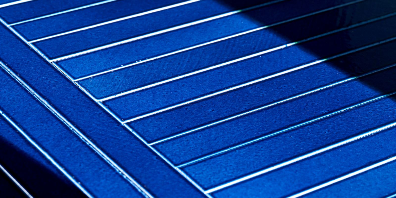 Grid of vibrant blue enameled lava stone tiles with a glossy, crackled finish.